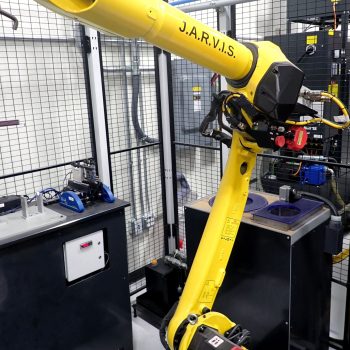 Fanuc M-10iD/8L 6-axis robotic cell with controller, marking station, and safety fencing